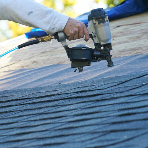 Roofer Installs Shingle Roofing.